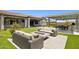 Gorgeous backyard with patio, fire pit, lounge seating, outdoor kitchen, and lush landscaping at 20797 W Rattler Rd, Buckeye, AZ 85396