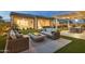 Outdoor living space boasts a modern fire pit, comfortable seating, and a serene backyard setting at 20797 W Rattler Rd, Buckeye, AZ 85396