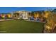 Expansive backyard featuring a covered dining area, built-in grill, fire pit, lush landscaping, and ample space at 20797 W Rattler Rd, Buckeye, AZ 85396