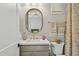 Charming bathroom featuring an oval mirror, designer accents, and ample lighting at 20797 W Rattler Rd, Buckeye, AZ 85396