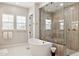 Elegant bathroom featuring a freestanding tub, glass shower, and neutral color palette at 20797 W Rattler Rd, Buckeye, AZ 85396