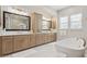 Bright bathroom boasting dual sinks, large mirrors, ample counter space, and soaking tub at 20797 W Rattler Rd, Buckeye, AZ 85396