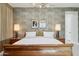 Bedroom with stylish decor, a wooden bed, textured accent wall, and ambient lighting at 20797 W Rattler Rd, Buckeye, AZ 85396