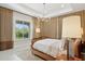 Bedroom with stylish decor, a wooden bed, a window with a view, and ambient lighting at 20797 W Rattler Rd, Buckeye, AZ 85396