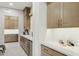 Butlery with quartz countertops, light colored cabinets, and a wine fridge at 20797 W Rattler Rd, Buckeye, AZ 85396