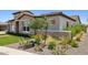 The exterior shows desert landscaping, a stone accent wall, and a tiled roof at 20797 W Rattler Rd, Buckeye, AZ 85396
