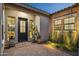 Charming covered front porch with elegant planters and stone tiled patio at 20797 W Rattler Rd, Buckeye, AZ 85396