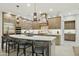 Beautiful kitchen with stainless steel appliances, breakfast bar, and modern light fixtures at 20797 W Rattler Rd, Buckeye, AZ 85396