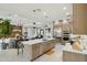 Bright kitchen with stainless steel appliances, a center island, and light colored cabinets at 20797 W Rattler Rd, Buckeye, AZ 85396