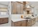 Kitchen with light cabinets, a modern range hood, and a gas cooktop at 20797 W Rattler Rd, Buckeye, AZ 85396