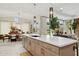 Kitchen island with a breakfast bar, a dining area, and a sitting area beyond at 20797 W Rattler Rd, Buckeye, AZ 85396