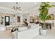 Bright living room featuring a cozy seating area, modern lighting, and open access to the kitchen at 20797 W Rattler Rd, Buckeye, AZ 85396
