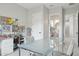 Bright home office featuring modern desk, decor, and access to an ensuite bathroom at 20797 W Rattler Rd, Buckeye, AZ 85396