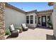 Cozy outdoor patio featuring comfortable seating and a well-maintained brick floor at 20797 W Rattler Rd, Buckeye, AZ 85396