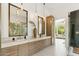 Bright bathroom featuring double sinks and stylish vanity with view to bedroom seating area at 21240 N 74Th Pl, Scottsdale, AZ 85255