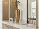 Bathroom featuring double sinks and stylish vanity with a stunning gold vase as the centerpiece at 21240 N 74Th Pl, Scottsdale, AZ 85255