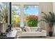 Comfortable seating area in bedroom with view to landscaped yard at 21240 N 74Th Pl, Scottsdale, AZ 85255