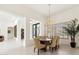 Bright, open dining room with large windows and stylish light fixtures at 21240 N 74Th Pl, Scottsdale, AZ 85255