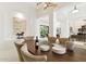 Dining room area features an oval table with plush seating, modern decor and open floor plan at 21240 N 74Th Pl, Scottsdale, AZ 85255