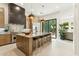 Spacious kitchen features an island with seating, stainless steel appliances, and access to the backyard at 21240 N 74Th Pl, Scottsdale, AZ 85255