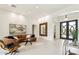 Bright living room with leather couch, modern decor, and black-framed glass front door at 21240 N 74Th Pl, Scottsdale, AZ 85255