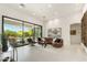 Open concept living room with large glass doors and view to landscaped pool and patio area at 21240 N 74Th Pl, Scottsdale, AZ 85255