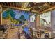Outdoor kitchen and dining area with a covered pergola, overlooking the pool and spa at 21240 N 74Th Pl, Scottsdale, AZ 85255