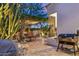 Inviting outdoor space with a grill, dining area, and desert landscaping, perfect for entertaining at 21240 N 74Th Pl, Scottsdale, AZ 85255