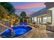 Lush backyard featuring a pool and hot tub, surrounded by palm trees and modern architecture at 21240 N 74Th Pl, Scottsdale, AZ 85255