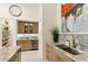 Features a wet bar with marble countertops, custom cabinetry, and stainless steel beverage cooler at 21240 N 74Th Pl, Scottsdale, AZ 85255