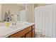Bright bathroom featuring a white vanity top, wood cabinets, and decorative wall art for a cozy atmosphere at 2150 W Alameda Rd # 1313, Phoenix, AZ 85085