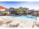 Community pool with lounge chairs and umbrellas, providing a relaxing space for residents at 2150 W Alameda Rd # 1313, Phoenix, AZ 85085
