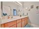 Well-lit bathroom featuring a vanity with wooden cabinets, white countertops, and decorative accents at 21968 W Hadley St, Buckeye, AZ 85326