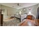 Cozy bedroom features a wrought iron bed, wood floors, and a large area rug at 21968 W Hadley St, Buckeye, AZ 85326