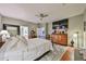 Spacious bedroom with a ceiling fan, TV, and a door to the bathroom at 21968 W Hadley St, Buckeye, AZ 85326
