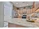 Kitchen island featuring granite countertops, stainless steel appliances, and generous storage at 21968 W Hadley St, Buckeye, AZ 85326