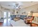 Spacious living room with hardwood floors, a ceiling fan, and comfortable seating arrangement at 21968 W Hadley St, Buckeye, AZ 85326