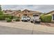 Traditional home with mature landscaping, two-car garage, and driveway parking at 21968 W Hadley St, Buckeye, AZ 85326
