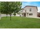 Expansive backyard featuring lush lawn and a view of the two-story home at 2438 W Via Dona Rd, Phoenix, AZ 85085