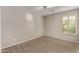 Bedroom features neutral walls, carpeted floors, and a shuttered window at 2438 W Via Dona Rd, Phoenix, AZ 85085