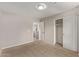 This bedroom features neutral walls, carpeted floors, and a closet at 2438 W Via Dona Rd, Phoenix, AZ 85085