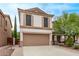 Two-story home with a two-car garage, neutral stucco, and desert landscaping at 2438 W Via Dona Rd, Phoenix, AZ 85085