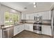 Well-lit kitchen with stainless steel appliances and white cabinetry offers a modern and clean aesthetic at 2438 W Via Dona Rd, Phoenix, AZ 85085