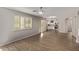 Spacious living room with hardwood floors and natural light, connecting seamlessly to the kitchen at 2438 W Via Dona Rd, Phoenix, AZ 85085