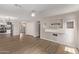 Open-concept living room with hardwood floors and recessed lighting flows into kitchen at 2438 W Via Dona Rd, Phoenix, AZ 85085