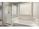 Bright bathroom features separate shower and tub with privacy block window at 2438 W Via Dona Rd, Phoenix, AZ 85085