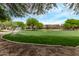 Wide park with soccer goal and play structure, surrounded by trees and greenery at 2438 W Via Dona Rd, Phoenix, AZ 85085