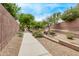 Community walking path is surrounded with desert landscaping at 2438 W Via Dona Rd, Phoenix, AZ 85085