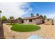 Fenced backyard with artificial turf and playset at 2551 E Harmony Ave, Mesa, AZ 85204