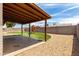 Spacious backyard featuring gravel, artificial grass, and a covered patio at 2551 E Harmony Ave, Mesa, AZ 85204